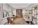 Comfortable sitting area with a decorative hutch, neutral colors and a large window for natural light at 108 Lakestone Pkwy, Woodstock, GA 30188