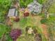 Aerial view of an expansive backyard featuring a firepit, shed, and lovely landscaping at 1765 Round Rd, Grayson, GA 30017