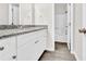 Bathroom vanity with granite countertop, sleek white cabinets, and modern fixtures at 1765 Round Rd, Grayson, GA 30017