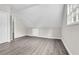Bright bedroom with neutral walls, gray vinyl floor, and natural light from the large window at 1765 Round Rd, Grayson, GA 30017