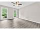 Well-lit bedroom with hardwood floors and two windows, offering a serene and calming ambiance at 1765 Round Rd, Grayson, GA 30017