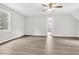 A bedroom with gray vinyl flooring, neutral walls, and a large window with natural light at 1765 Round Rd, Grayson, GA 30017