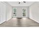 Bedroom featuring hardwood floors, two windows, and a closet providing ample storage at 1765 Round Rd, Grayson, GA 30017