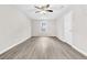A bright bedroom featuring gray vinyl flooring, neutral walls, and a ceiling fan at 1765 Round Rd, Grayson, GA 30017