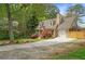 Charming home featuring an attached garage, dormer windows, mature trees, and a long driveway at 1765 Round Rd, Grayson, GA 30017