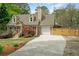 Charming home featuring an attached garage, dormer windows, mature trees, and a concrete driveway at 1765 Round Rd, Grayson, GA 30017