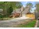 Charming home with lush lawn, dormer windows, wooden privacy fence, and attached garage at 1765 Round Rd, Grayson, GA 30017