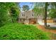 Charming home featuring manicured front yard, dormer windows, front porch, and attached garage at 1765 Round Rd, Grayson, GA 30017