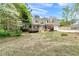 Charming home featuring manicured front lawn with attached garage and wooden privacy fence at 1765 Round Rd, Grayson, GA 30017