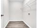 A clean, minimalist laundry room equipped with essential hookups and storage shelving at 1765 Round Rd, Grayson, GA 30017