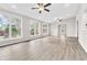 Spacious, airy living room with hardwood flooring and multiple windows for ample natural light at 1765 Round Rd, Grayson, GA 30017