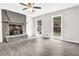 Bright and airy living room featuring gray walls, laminate flooring, stone fireplace and ample natural light at 1765 Round Rd, Grayson, GA 30017