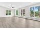 Open living room featuring plenty of windows, laminate floors, neutral walls, and a ceiling fan at 1765 Round Rd, Grayson, GA 30017