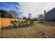A spacious backyard featuring a wood fence, rock landscaping, and mature trees at 3028 Hallman Cir, Marietta, GA 30064