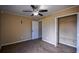 Carpeted bedroom with a ceiling fan, closet, and an open door to another room at 3028 Hallman Cir, Marietta, GA 30064