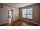 Cozy bedroom with hardwood floors, fresh paint, and a window with wooded outdoor views at 3028 Hallman Cir, Marietta, GA 30064