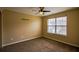 Neutral bedroom featuring plush carpeting, a ceiling fan, and a window at 3028 Hallman Cir, Marietta, GA 30064
