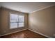 Neutral bedroom with hardwood flooring, white trim, and a window providing natural light at 3028 Hallman Cir, Marietta, GA 30064