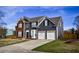 Beautiful home with a two-car garage, brick details, nice landscaping, and a freshly mowed lawn at 3028 Hallman Cir, Marietta, GA 30064
