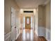 Bright foyer featuring hardwood floors, white wainscoting, and a decorative front door at 3028 Hallman Cir, Marietta, GA 30064