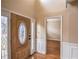 Warm entryway with hardwood flooring, white wainscoting, and a wooden front door with glass at 3028 Hallman Cir, Marietta, GA 30064