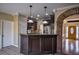 Open kitchen area with modern appliances, granite countertops, bar and brick archway at 3028 Hallman Cir, Marietta, GA 30064