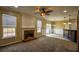 Open-concept living room with fireplace, ceiling fan and access to the backyard at 3028 Hallman Cir, Marietta, GA 30064