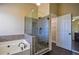 Gorgeous primary bath with a soaking tub and a glass enclosed shower and tiled walls at 3028 Hallman Cir, Marietta, GA 30064