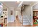 Inviting foyer with hardwood floors, staircase, and open view to the living spaces at 480 Shore Drive, Suwanee, GA 30024