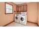 Laundry room with washer, dryer and storage cabinets at 480 Shore Drive, Suwanee, GA 30024