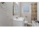 Bathroom with white vanity, decorative mirror and shower/tub combo at 2212 Brannen Se Rd, Atlanta, GA 30316