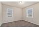 Inviting bedroom with neutral paint, soft carpet and bright light from the dual paned windows at 2212 Brannen Se Rd, Atlanta, GA 30316