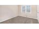 Bright bedroom features plush carpeting, neutral walls, and a window with blinds for natural light at 2212 Brannen Se Rd, Atlanta, GA 30316