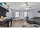 Inviting living room featuring neutral paint, a ceiling fan, and wood-look flooring at 2228 Christian Cir, Conyers, GA 30013