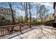 View of the backyard from the deck, showcasing a wooden fence, trees, and greenery at 29 Cliftwood Dr, Sandy Springs, GA 30328