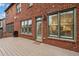 Spacious back deck featuring a brick exterior, large windows, and a door leading inside at 29 Cliftwood Dr, Sandy Springs, GA 30328