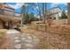 Large backyard with a stone pathway, retaining wall, and lush greenery at 29 Cliftwood Dr, Sandy Springs, GA 30328
