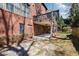 Large backyard featuring a patio, deck, stone pathway, and lush greenery at 29 Cliftwood Dr, Sandy Springs, GA 30328