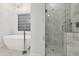 Modern bathroom with a standalone tub and a luxurious marble tiled shower with glass door at 29 Cliftwood Dr, Sandy Springs, GA 30328
