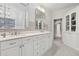 Bright bathroom features double vanity, stone backsplash, and built-in storage at 29 Cliftwood Dr, Sandy Springs, GA 30328