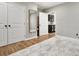 Bright bedroom with wood floors and a large closet with white doors and an elegant mirror on the wall at 29 Cliftwood Dr, Sandy Springs, GA 30328