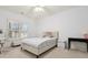 Bedroom featuring carpet floors, white walls, a modern bed, and natural light from the shuttered window at 29 Cliftwood Dr, Sandy Springs, GA 30328