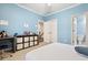 This bedroom features a light blue paint, white trim and doors, with neutral carpet flooring at 29 Cliftwood Dr, Sandy Springs, GA 30328