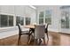 Cozy dining area with a round table, modern chairs, hardwood floors, and natural light from shuttered windows at 29 Cliftwood Dr, Sandy Springs, GA 30328