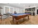 A billiard table complements a wet bar and wine fridge in this spacious game room with hardwood floors at 29 Cliftwood Dr, Sandy Springs, GA 30328