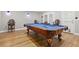Spacious game room featuring a billiard table, hardwood floors, and elegant spindle back chairs at 29 Cliftwood Dr, Sandy Springs, GA 30328