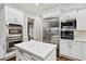 Elegant kitchen featuring stainless steel appliances, custom cabinetry, and a central island at 29 Cliftwood Dr, Sandy Springs, GA 30328