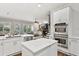 Open kitchen with white cabinets, stainless appliances, and view into connected living space at 29 Cliftwood Dr, Sandy Springs, GA 30328