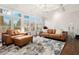 Bright living area with coffered ceilings, hardwood floors, large windows, and plantation shutters at 29 Cliftwood Dr, Sandy Springs, GA 30328