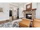 Cozy living room with a stone fireplace, hardwood floors, and leather furniture at 29 Cliftwood Dr, Sandy Springs, GA 30328